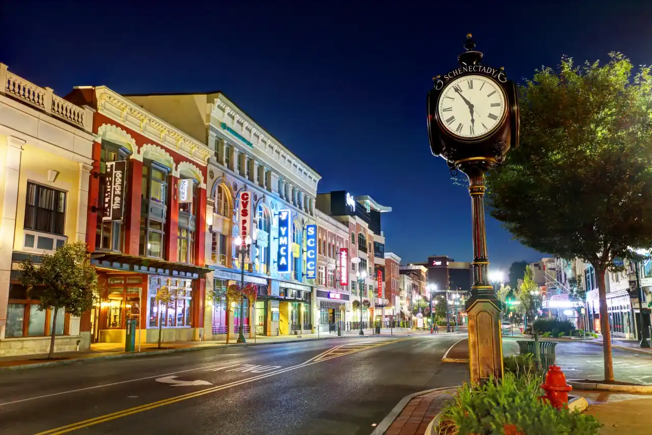 Downtown Schenectady at dusk, with the Jay Street clock and lit storefronts